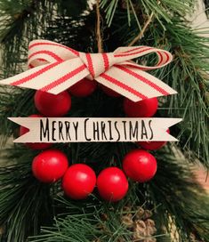 a merry christmas ornament hanging from a tree