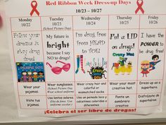 a red ribbon week poster is hanging on the wall in front of a bulletin board