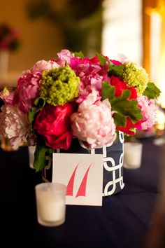 flowers and candles are sitting on a table