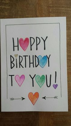 a handmade birthday card with hearts and arrows on the front, says happy birthday to you