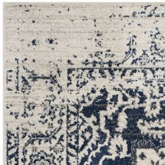 an area rug with blue and white designs on it