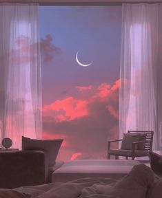 the moon is seen through curtains in this bedroom window sill, with two chairs and a coffee table on one side