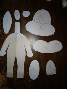 paper cut out of the shape of a man's body and head with other items