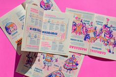 several pamphlets are laying on top of each other in front of a bright pink background