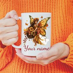 a woman holding a coffee mug with a fairy on it's side and the words, your name