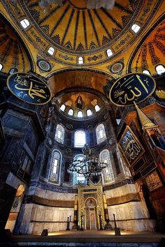 the inside of an ornate building with stained glass windows