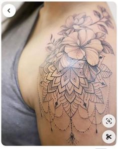 a woman's shoulder with flowers on it and an arrow drawn in the middle