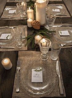 a table set with place settings and candles