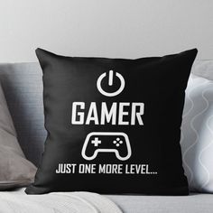 a black pillow with the words gamer just one more level and a video game controller on it