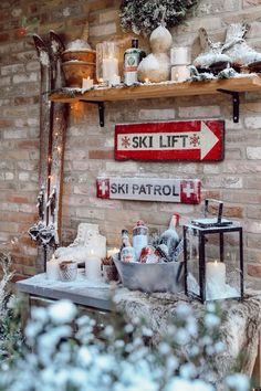 a ski lift sign above a table with candles and other items on top of it