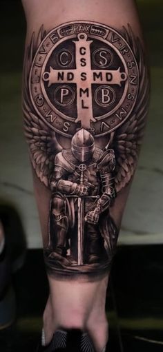 a person with a cross and wings on their leg