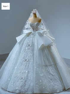 a white wedding dress on display in front of a mannequin's head