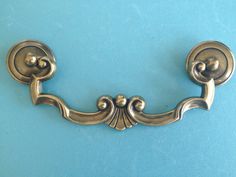 an antique style door handle on a blue background