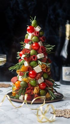 a christmas tree made out of olives, tomatoes and cheese