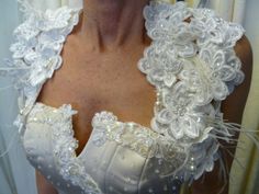 a woman wearing a white dress with flowers on it