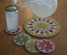 a pitcher and some coasters on a table