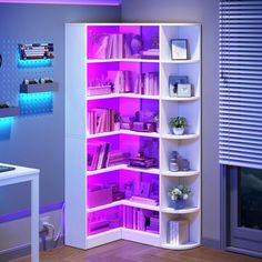 a white book shelf filled with lots of books and other items next to a window