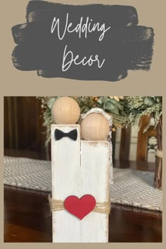 two wooden pegs with hearts and bow ties on them