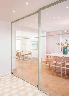 an empty room with glass walls and chairs