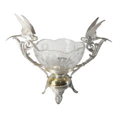 an ornate glass bowl with two birds on the top and one bird on the bottom