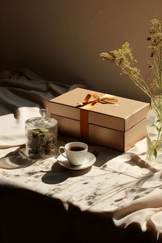 A cup of tea and a gift box on a table, bathed in warmly lit ambiance. Summer Morning, A Cup Of Tea