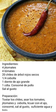 a bowl filled with chili and chips on top of a table