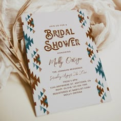 a bridal shower is shown on top of a white sheet with brown and blue accents