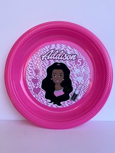 a pink frisbee with an image of a woman's face on it