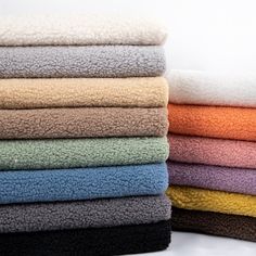 a stack of folded towels sitting on top of each other