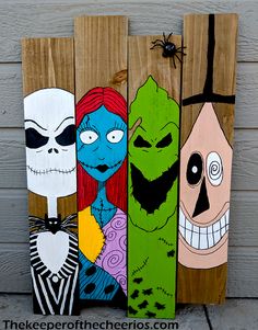 three skateboards painted to look like cartoon characters