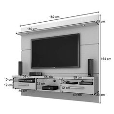 a tv mounted to the side of a wall next to a shelf filled with speakers