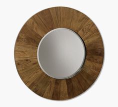 a round wooden mirror on a white wall with wood grained finish and metal frame