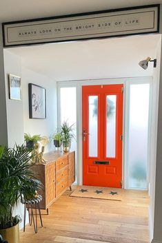 a bright orange door is in the entry way