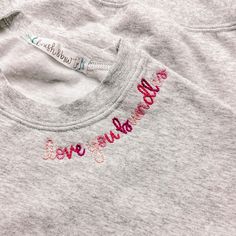 a t - shirt with the words you're awesome embroidered on it in pink and red