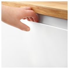 a person's hand on the edge of a counter