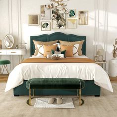 a bedroom with white walls, green headboard and gold accents on the bedding