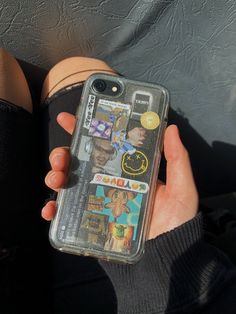 a person holding an iphone case with pictures on it