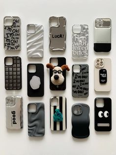 there are many different cell phones on the table together, including one with a dog's face