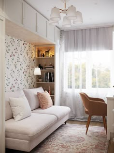 a living room filled with furniture and a white couch next to a book shelf on top of a hard wood floor