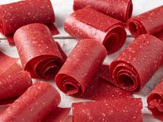 red rolled up dough sitting on top of a white countertop next to other food items