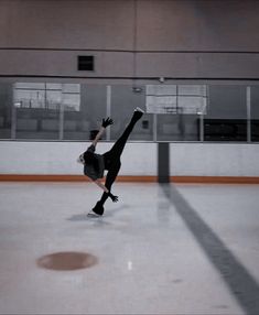 a skateboarder is doing a trick on the ice in an indoor skating rink