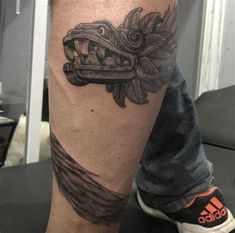 a man with a tattoo on his leg that has a car and flowers on it