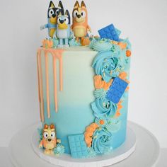 a birthday cake decorated with cartoon characters and icing