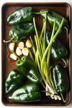 green peppers and garlic on a baking tray