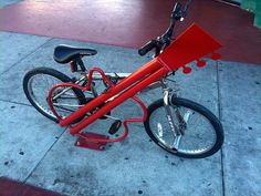 a red bicycle is parked on the sidewalk