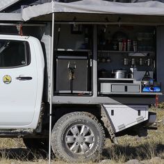 a white truck parked in front of a building with an awning on it's roof