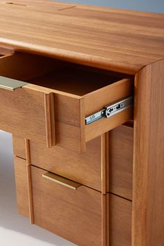 a wooden desk with two drawers on each side and an open drawer in the middle