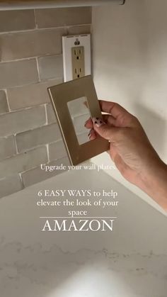 a person holding an electrical outlet in front of a brick wall with the words, easy ways to help elevate the look of your space