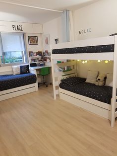 two bunk beds in a room with wood flooring and white walls, one has black polka dot sheets on it