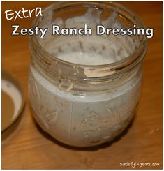 a jar filled with white liquid sitting on top of a wooden table